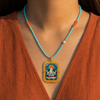 Eastern Luck Four-Armed Avalokiteshvara Deluxe 3D relief Tsatsa pendant — turquoise coral bead necklace worn — image 9 of 10