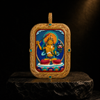 Manjushri hand-painted Tsatsa Thangka pendant on dark stone pedestal