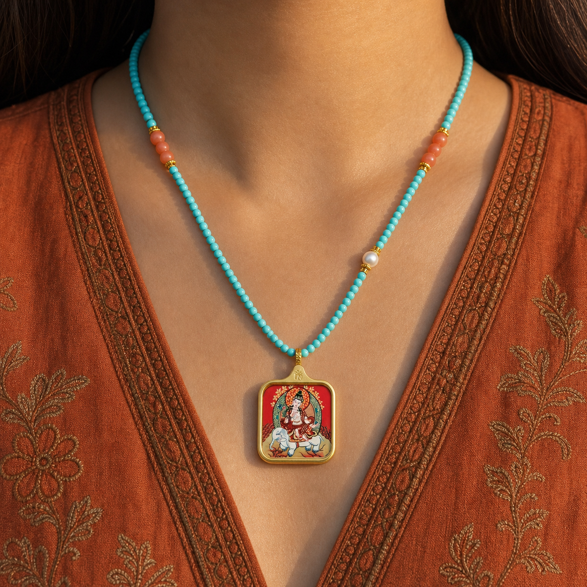 Samantabhadra titanium steel pendant worn with turquoise and coral beads