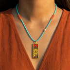 Eastern Luck Yellow Jambhala mini Tibetan thangka pendant — turquoise coral bead necklace worn — image 9 of 10